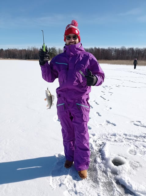 From Helsinki: Bodom Lake Ice Fishing with Food & Drinks - Warming up in a laavu: makara sausage, glögi, and piparri cookies