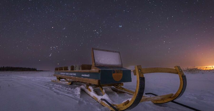 Ii: Snowmobile sleigh trip on frozen sea under starlit sky - Riding a Snowmobile Over the Frozen Sea Near Ii