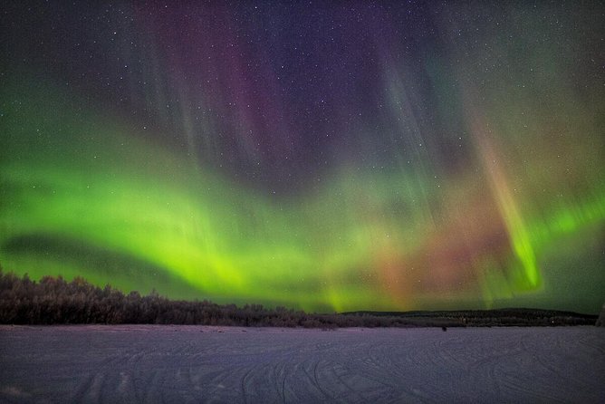Northern Lights Hunting with Snowmobiles - Snowmobile Driving Through Lapland Wilderness at Night