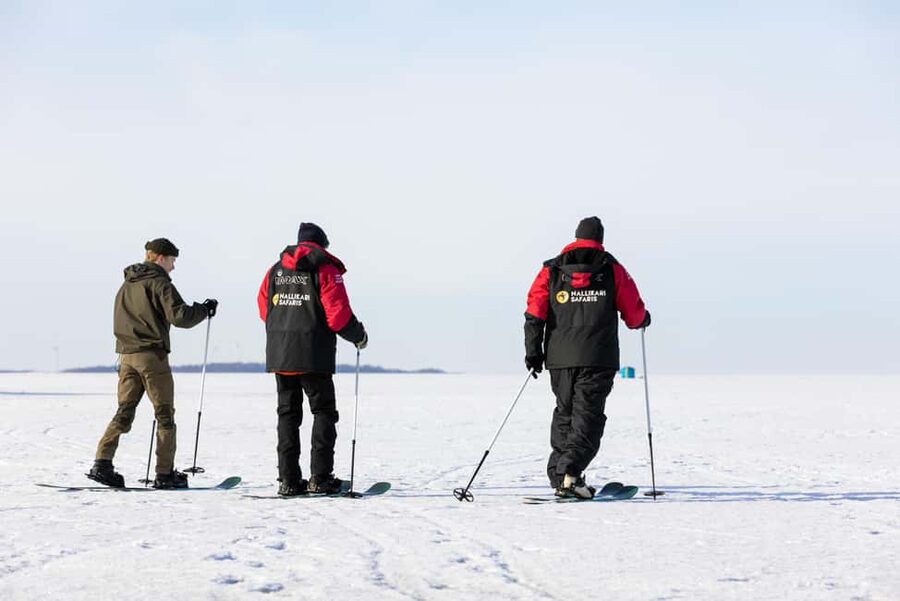 Oulu: Arctic Sea Snowshoe Experience - Watching a hole drilled through the sea ice