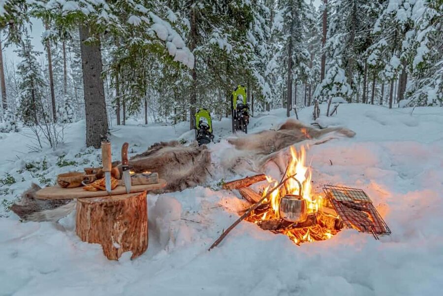 Snowshoe experience with traditional beverages in Lapland - Warm Open Fire, Berry Hot Juice, Cheese, and Sausage Made on the Fire
